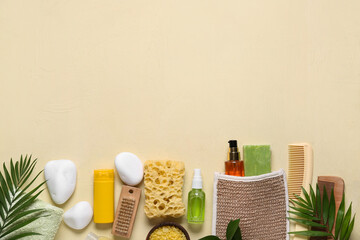 Obraz na płótnie Canvas Beautiful composition with different spa supplies and palm leaves on beige background