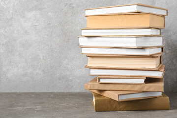 Stack of books on grey background