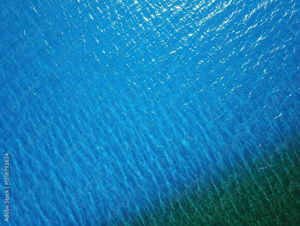 Poster close-up view of clear blue water with light reflections and gentle ripples creating a textured spar