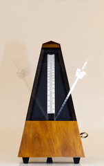 Wooden Mechanical Metronome With Blurred Arm In Motion