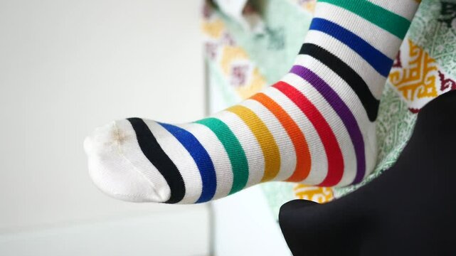 Putting on colorful striped socks for children
