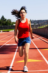 Young Hispanic Teen Woman Running On Track