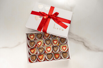 Box of assorted chocolates with a red bow and the word love.