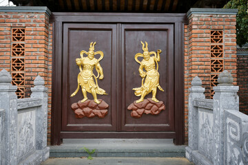 Portal decorated with golden protective deities