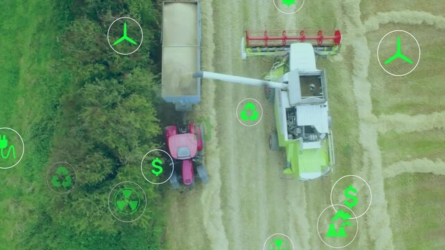 Aerial camera moving over field harvester cutting while tractor loading grain pulsing green icons