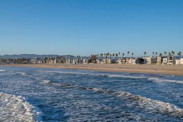 Waves in Pacific Ocean of Venice Beach California with blue sky