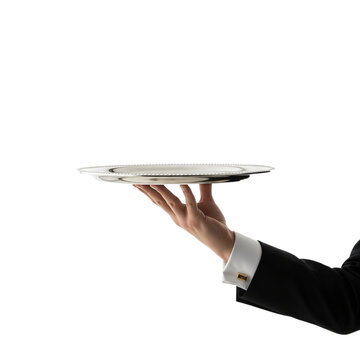 A person in formal attire, likely a waiter or server, holding up an empty silver platter. The hand is extended from the right side of the frame, holding the platter flat.