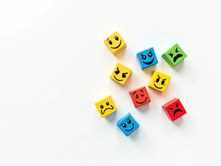 Obraz premium Colorful Cubes with Cartoon Facial Expressions Showing Emotions Like Happy, Sad, Angry, and Surprised on White Background for Emotional Learning, Kids Education, Therapy, and Creative Development Them