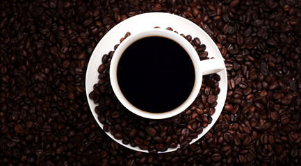 Freshly brewed black coffee in a white cup beside roasted beans on rustic table, capturing morning aroma, warmth, and cozy atmosphere.