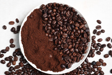 Close-up of roasted brown coffee beans piled together, showcasing rich texture, aroma, and freshness on a white studio background.