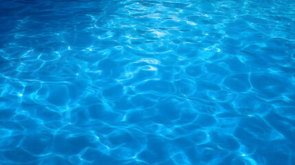 Obraz premium Blue water surface with gentle ripples and sunlight reflections, an abstract aquatic serenity.