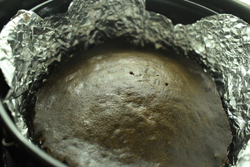 brown chocolate cake bake on aluminum foil paper