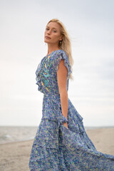 Fashion Editorial of Blonde Woman in Stylish Summer Outfit on Sunny Beach