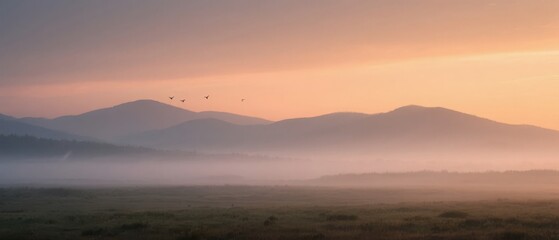 Obraz premium Dawn Over Misty Mountains with Birds in Flight