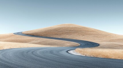 Scenic winding asphalt road curving through dry open grassland in a rural landscape under clear blue sky du daytime