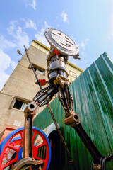 A robot sculpture made of train parts, holding a gun and shield, at Fan-Shaped Depot, captured on August 21, 2012, in Changhua County, Taiwan.