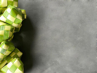 Ketupat on black floor background. Ketupat is a natural rice casing made from young coconut leaves for cooking rice during eid mubarak.