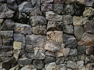 Stack of neatly arranged rocks, textured stone background