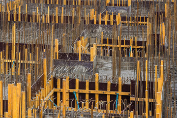 Construction site with formwork and rebar in progress outdoors, full-frame background
