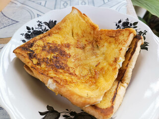 Golden French Toast Stack on Decorative Plate for Tasty Breakfas