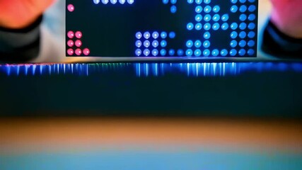 A researcher examines a flexible, luminous dot-matrix display panel, showcasing vibrant, colorful patterns in a modern laboratory setting - Powered by Adobe