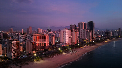 Vibrant da nang cityscape glowing with illuminated buildings stretching along coastal edge during...