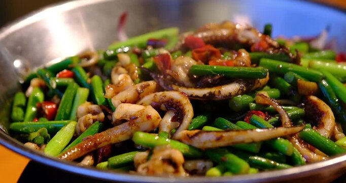 stir-fried squid with garlic sprouts close up