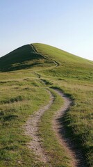 Scenic Pathway Winding Through Green Hills Leading to a Mountain Peak with Clear Blue Sky in a Tranquil Nature Landscape Scene Perfect for Outdoor Activities