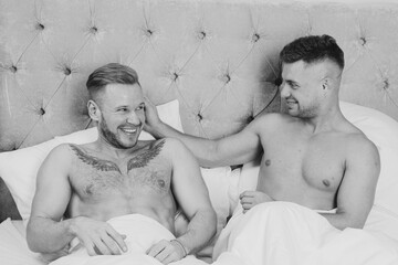 Young attractive couple relaxing on bed at home.