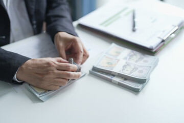 Elderly accountant counts banknotes during a cash audit. Senior asian business woman accounting.