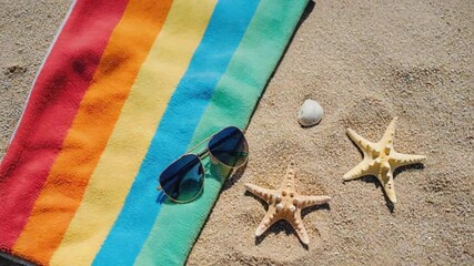 Beach Essentials on a Colorful Towel