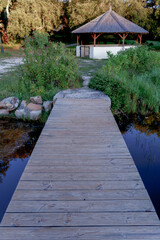 Montejaque,Malaga,Spain Tranquil scene of a wooden walkway leading to a peaceful gazebo, surrounded...