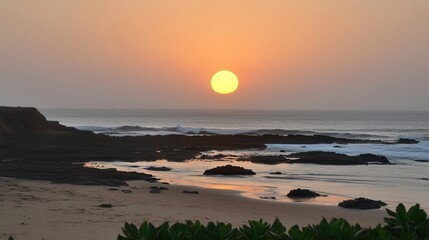 Serene Sunset over Ocean Rocks and Sandy Beach