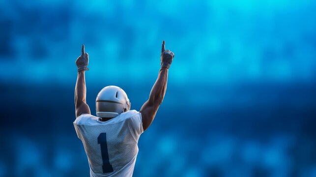 Football player celebrating victory with arms raised in triumph.