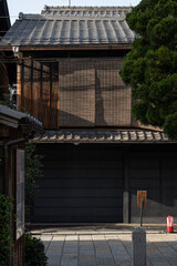 Vertical image of a wooden building exterior of an old Japanese house in the Gion district outdoor at daytime in Kyoto in Japan.