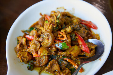 Close-up view of stir-fried spicy Boar in plate