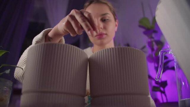  Woman adding perlite to flowerpot for plant repotting