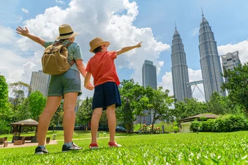 Crédence en verre imprimé Female tourist and her son enjoying cityscape of Kuala Lumpur