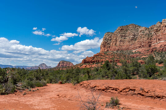Panoramic desert landscapes in Sedona, Arizona, featuring vivid red rock formations, green vegetation, and expansive blue skies. The images highlight the natural beauty of the rugged canyons - Powered by Adobe