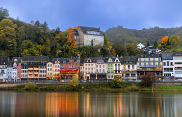 Colorful homes, shops and restaurants along Moselle river in Cochem, Germany.