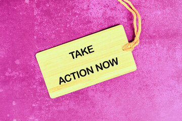 Encouraging motivation, productivity and determination concept. TAKE ACTION NOW written on the tag...