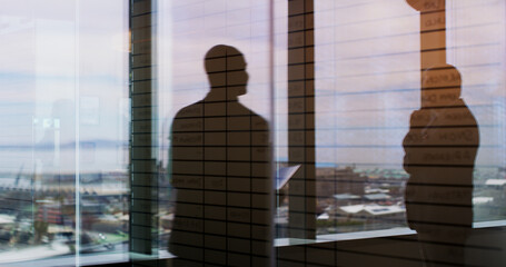 Business people, silhouette and window with reflection on balcony for corporate insight or travel. Colleagues, employees or double exposure with vision for negotiation on economic structure in city