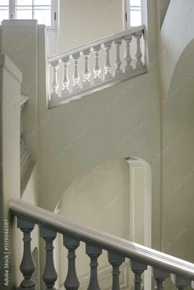 Poster elegant white staircase with intricate railings in a well-lit interior space showcasing architectura