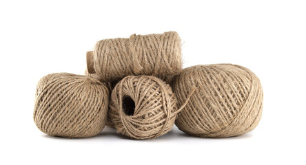 Close-up shot of several balls of rustic twine on a clean, bright white background.