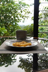 Typical Costa Rican breakfast: tortilla with egg and a glass of coffee or torta de huevo con tortilla
