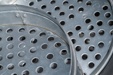 Wet steel grater with abstract water drops on shiny metal, an isolated kitchen cooking tool