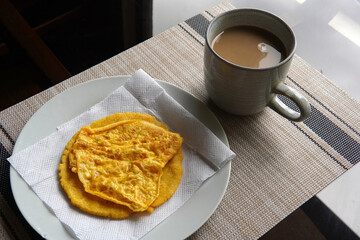 Typical Costa Rican breakfast: tortilla with egg and a glass of coffee or torta de huevo con tortilla