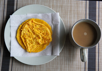 Typical Costa Rican breakfast: tortilla with egg and a glass of coffee or torta de huevo con tortilla