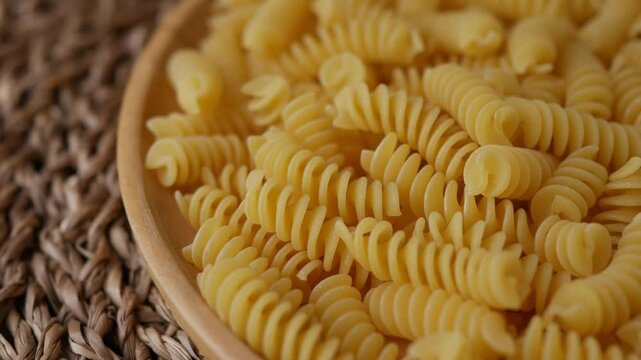 Raw Fusilli Spiral spaghetti pasta pattern background.