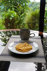 Typical Costa Rican breakfast: tortilla with egg and a glass of coffee or torta de huevo con tortilla